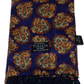 A Tootal brand silk scarf with a dark blue base and an orange, gold, and white paisley pattern, featuring a dark navy blue fringe and a black header card.
