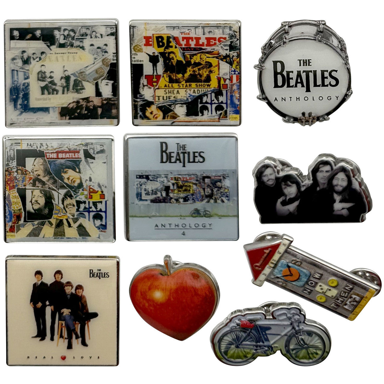 A set of nine The Beatles collectible enamel pins and badge designs arranged on a plain white background, featuring album art, band photos, a bicycle, a heart, and a drum motif.