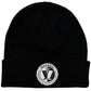 A black knit beanie hat with a folded cuff, featuring a circular white and black embroidered patch on the front that reads 'MADNESS' and includes a stylized M' emblem.