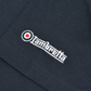 Close-up of a dark navy blue fabric garment featuring a white embroidered 'Lambretta' logo with a red target accent.