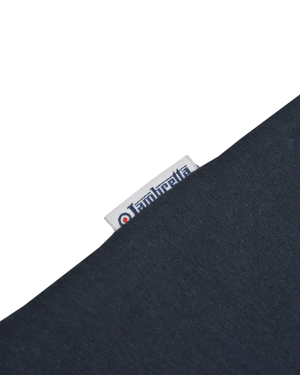 Close-up of a dark navy blue knit fabric with a small white brand tag reading Ambreta.